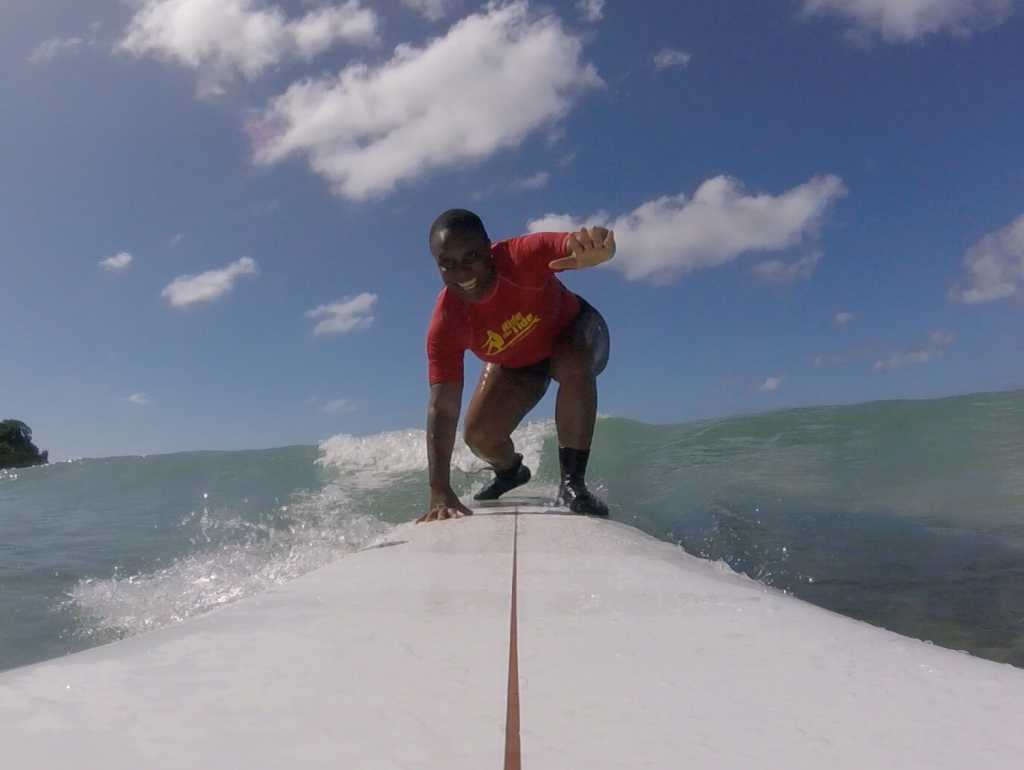 Woman learning to surf at surf school Ride the tide Barbados